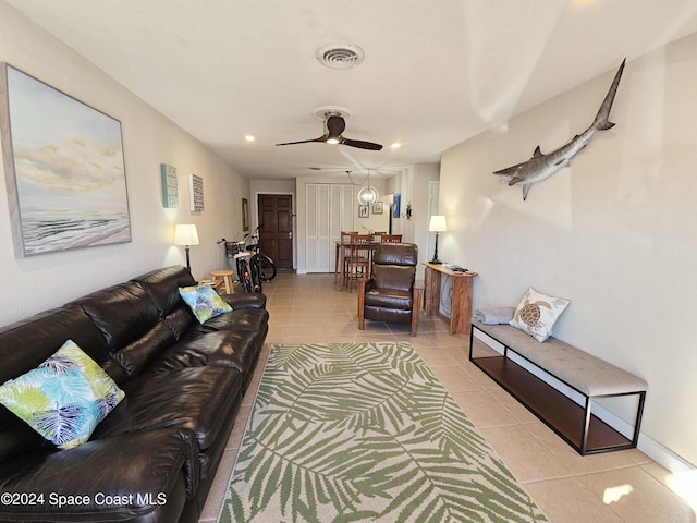 living room featuring ceiling fan and light tile patterned floors