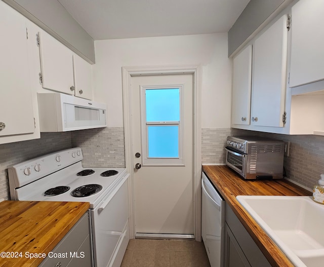 kitchen featuring wooden counters, white appliances, white cabinetry, and sink