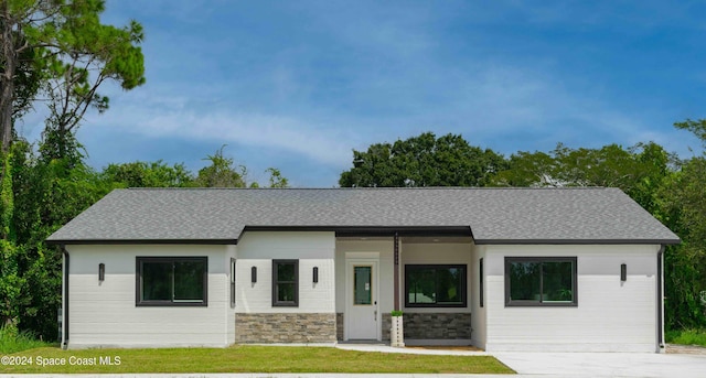 3470 W Eau Gallie Blvd, Melbourne, FL 32935 - modern farmhouse style home with a shingled roof, stone siding, and a front lawn