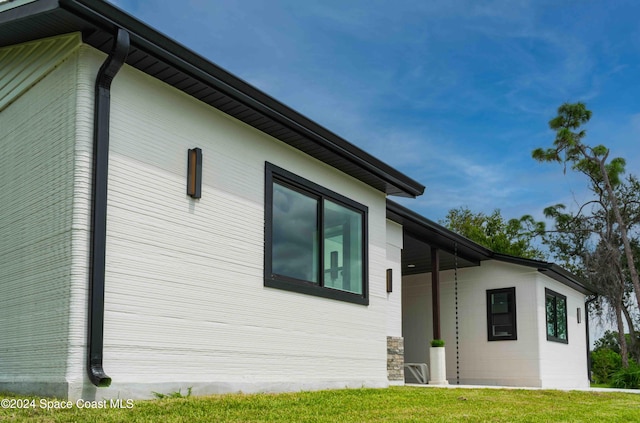 view of home's exterior with a yard