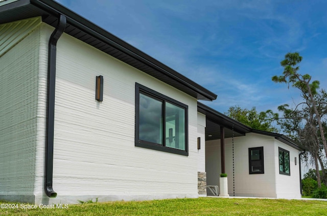 3470 W Eau Gallie Blvd, Melbourne, FL 32935 - view of home's exterior with a yard