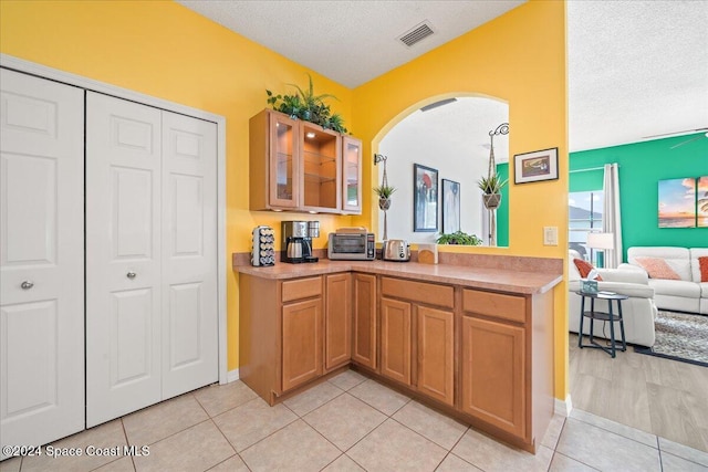 kitchen featuring light tile patterned floors and a textured ceiling