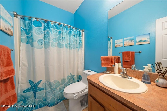 bathroom with a shower with shower curtain, vanity, and toilet