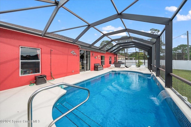 view of pool with a lanai, pool water feature, and a patio