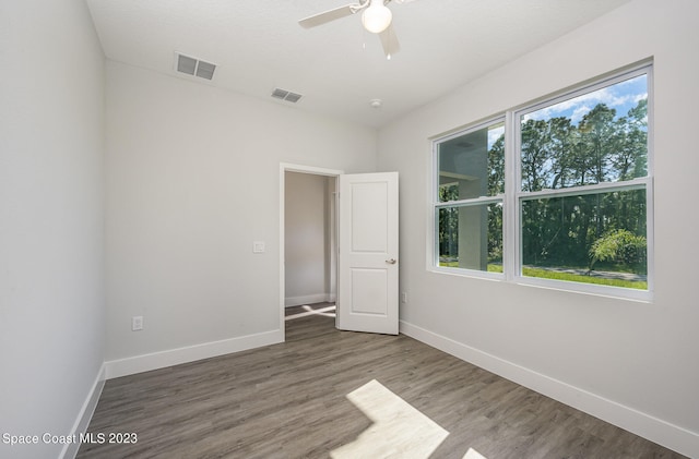 spare room with hardwood / wood-style floors and ceiling fan