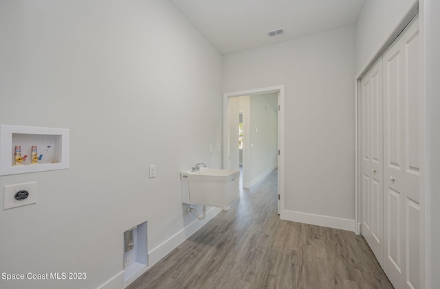 laundry area featuring hookup for an electric dryer, hookup for a washing machine, and light wood-type flooring