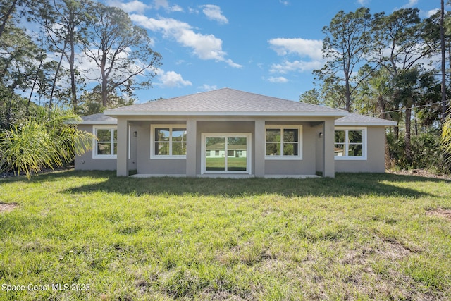 back of house with a lawn