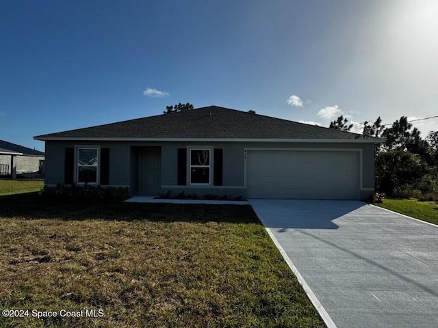 ranch-style home with a garage and a front lawn