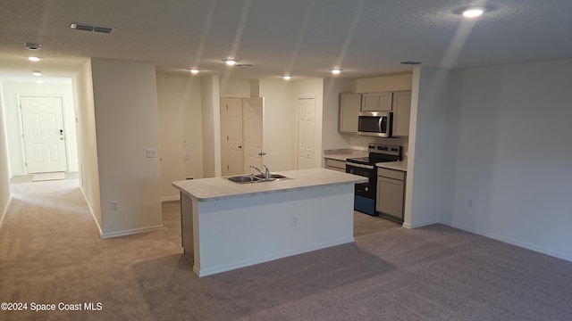 527 Poplar St SE, Palm Bay, FL 32909 - kitchen with gray cabinetry, stainless steel appliances, light carpet, and an island with sink