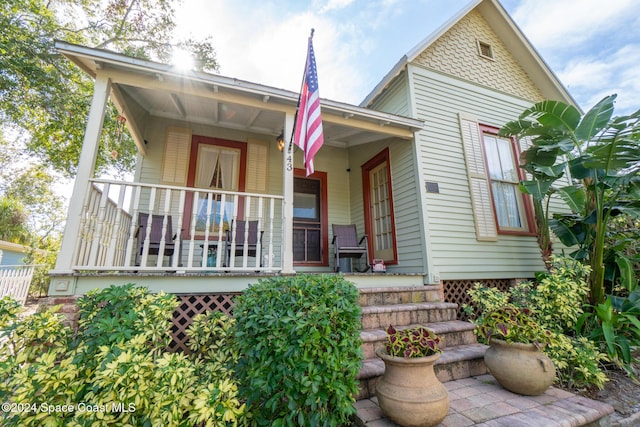 back of property with covered porch