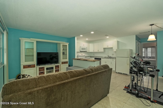 6590 Odyssey St Unit I, Cape Canaveral, FL 32920 - living room with light tile patterned flooring and recessed lighting