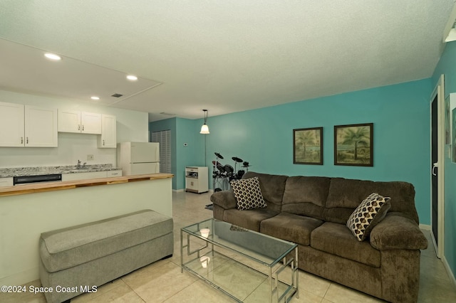 6590 Odyssey St Unit I, Cape Canaveral, FL 32920 - living area with recessed lighting, light tile patterned floors, and a textured ceiling