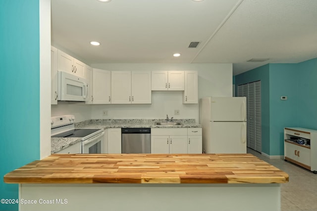 kitchen with white cabinets, wood counters, white appliances, and sink