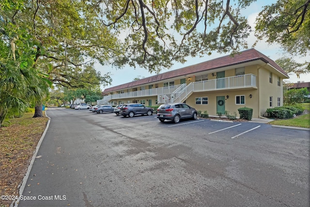 6590 Odyssey St Unit I, Cape Canaveral, FL 32920 - view of building exterior featuring uncovered parking and stairs