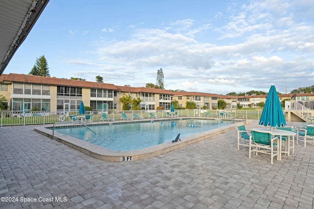 view of swimming pool with a patio area