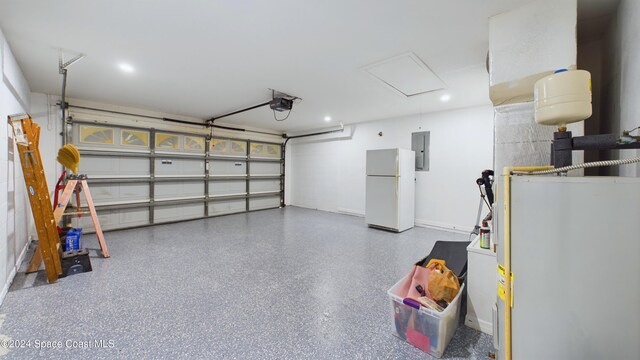 garage with electric panel, white refrigerator, electric water heater, and a garage door opener