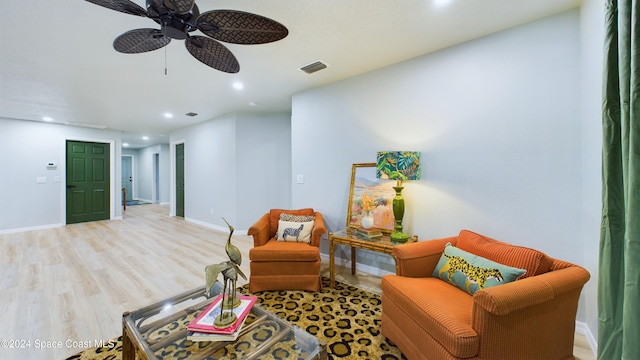 sitting room with ceiling fan and light hardwood / wood-style floors