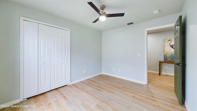 unfurnished bedroom with light wood-type flooring, a closet, and ceiling fan