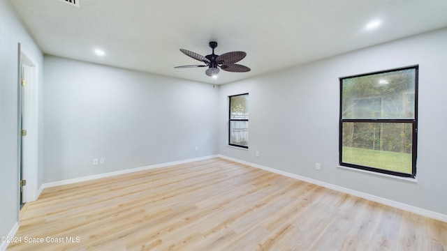 unfurnished room with light hardwood / wood-style flooring, a wealth of natural light, and ceiling fan