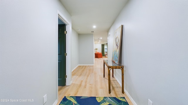 hallway with hardwood / wood-style flooring