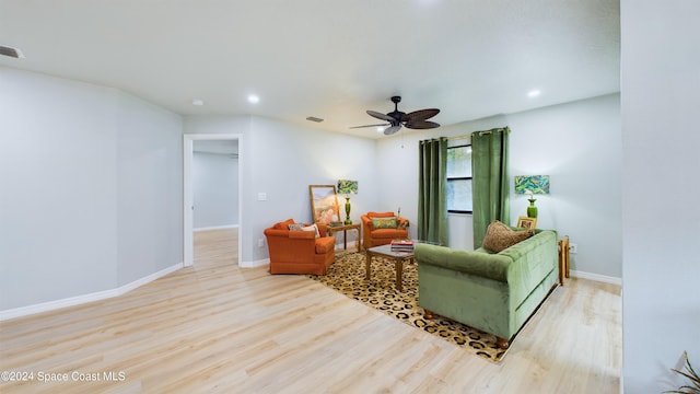 living room with ceiling fan and light wood-type flooring