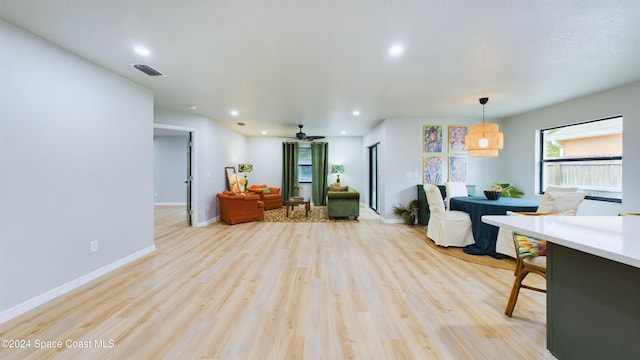 living room with ceiling fan and light wood-type flooring