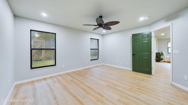 spare room featuring ceiling fan and light hardwood / wood-style floors