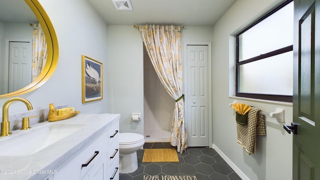 bathroom with tile patterned flooring, vanity, and toilet