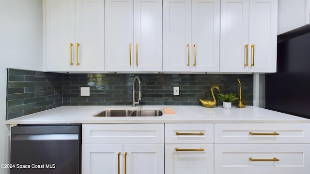 kitchen featuring white cabinets, decorative backsplash, dishwashing machine, and sink