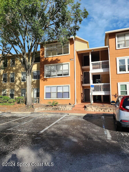 view of building exterior featuring uncovered parking