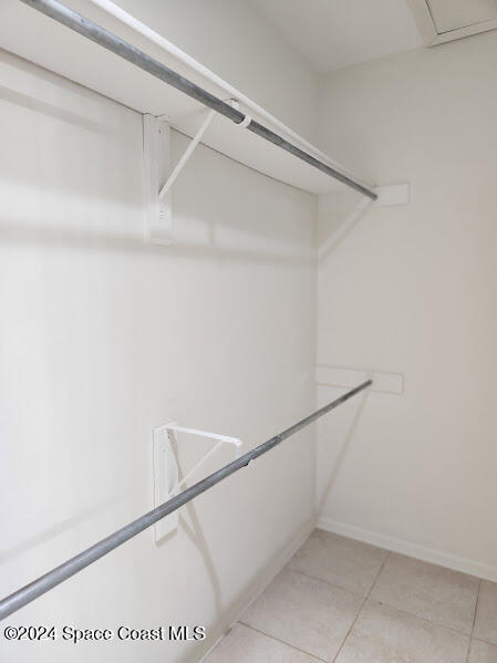 spacious closet featuring light tile patterned floors