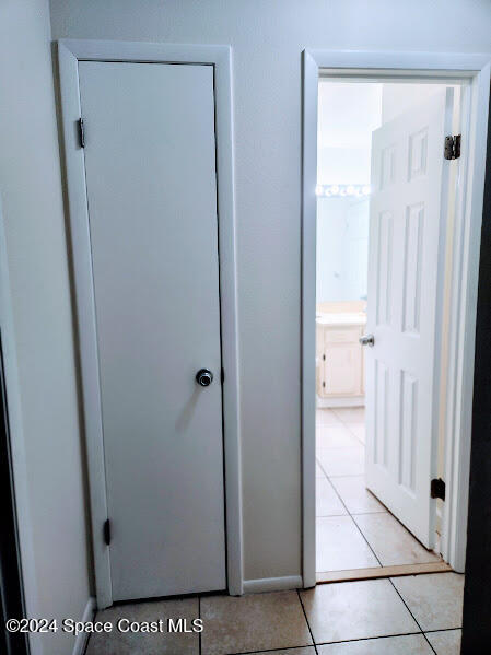 corridor featuring light tile patterned flooring