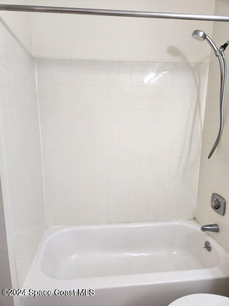 full bath featuring shower / bath combination and toilet