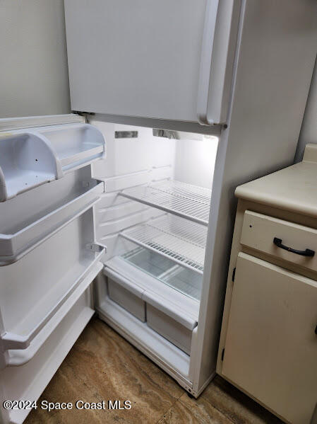 interior details with light countertops and white fridge