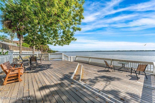 wooden terrace with a water view