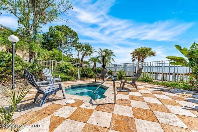 view of pool featuring a patio area, a hot tub, and fence