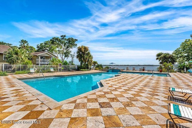 pool with fence and a patio