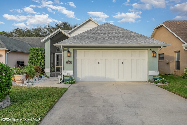 view of front facade with a front yard and a garage