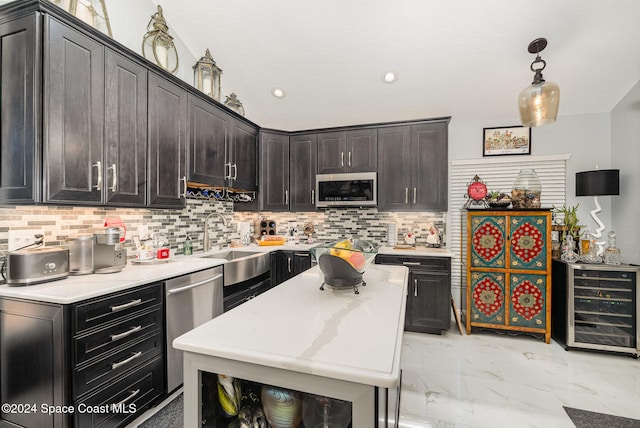 kitchen with sink, beverage cooler, stainless steel appliances, pendant lighting, and decorative backsplash