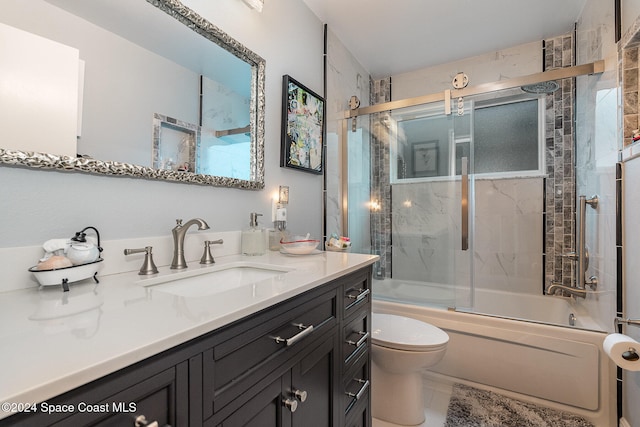 full bathroom with tile patterned floors, toilet, vanity, and combined bath / shower with glass door