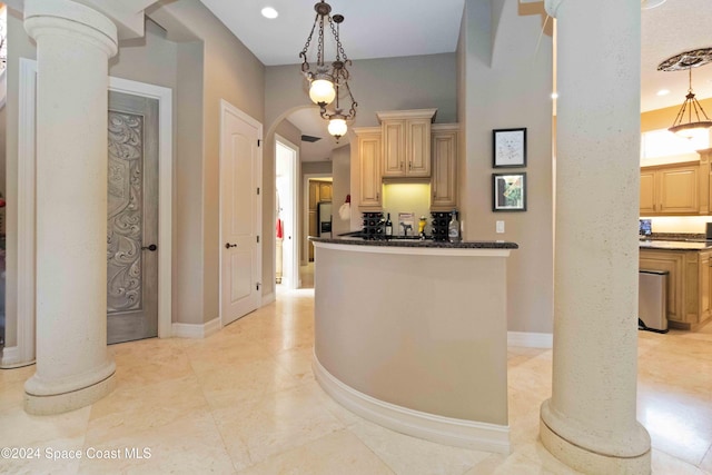 kitchen featuring pendant lighting, light brown cabinets, and decorative columns