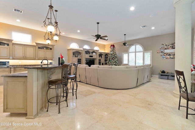 living room with ceiling fan with notable chandelier