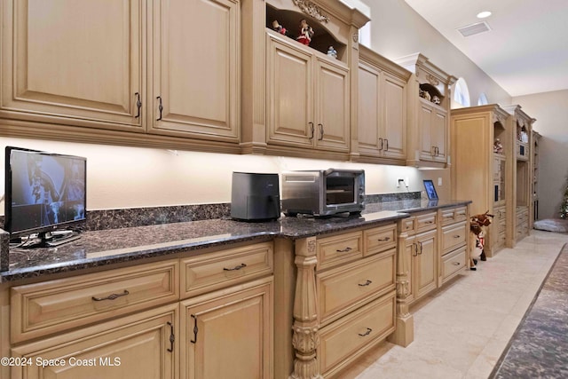 kitchen with open shelves, dark stone countertops, visible vents, and a toaster