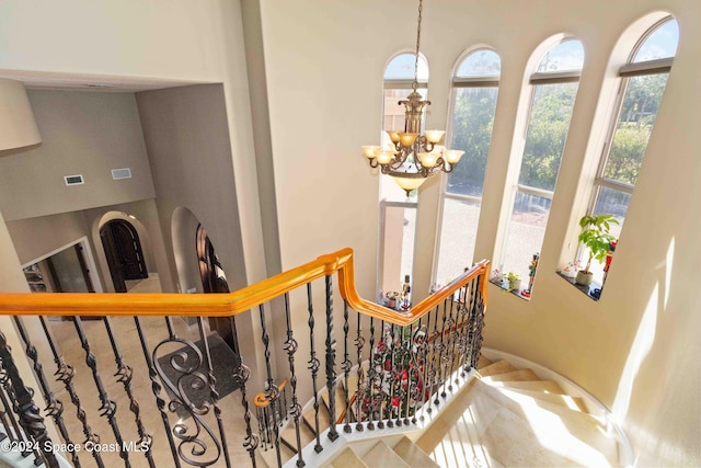 stairway featuring an inviting chandelier