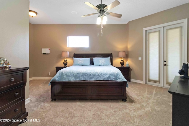 bedroom featuring ceiling fan, baseboards, and light colored carpet