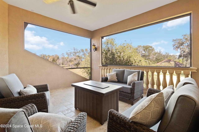 sunroom / solarium featuring a wealth of natural light and ceiling fan