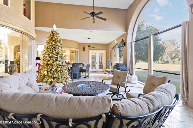 interior space with outdoor lounge area, french doors, and ceiling fan