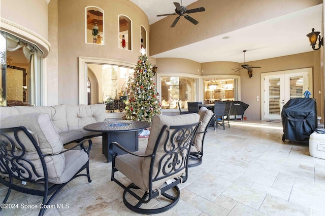 view of patio / terrace featuring a grill, ceiling fan, and an outdoor living space with a fire pit