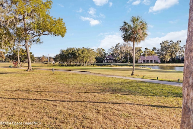 view of property's community featuring a water view and a lawn