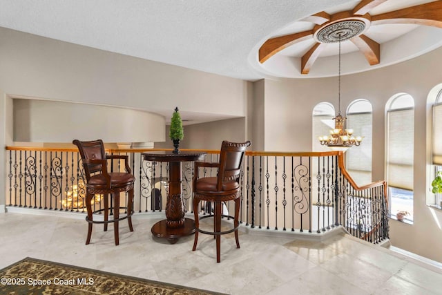 interior space featuring a chandelier and a textured ceiling